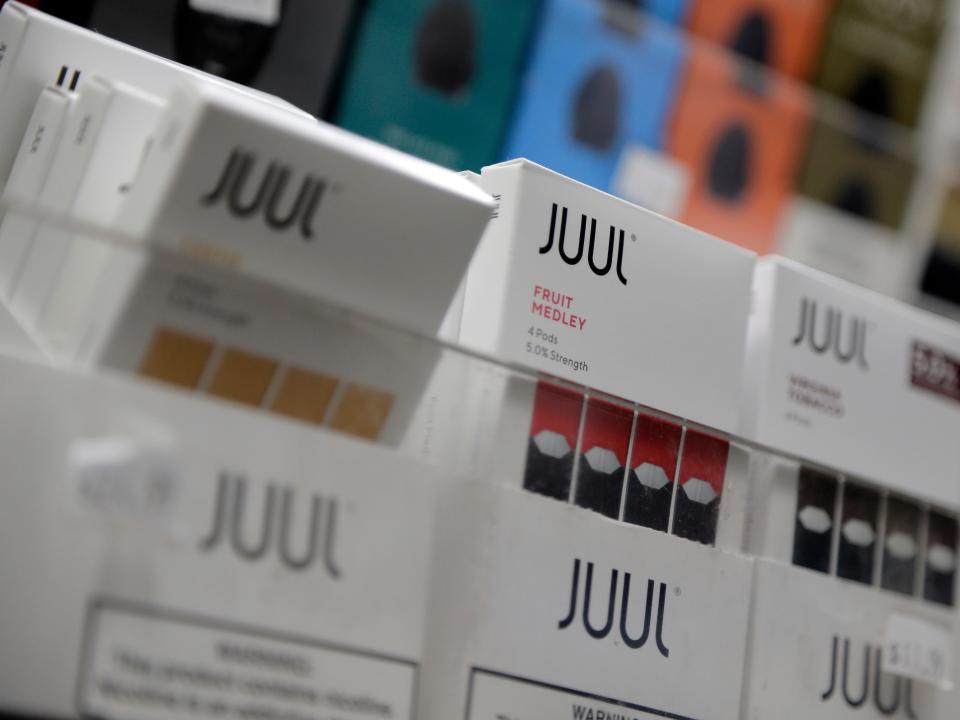 FILE - In this Dec. 20, 2018, file photo Juul products are displayed at a smoke shop in New York. The company that makes Marlboro cigarettes will take a $4.1 billion hit from its investment in Juul. Altria took a 35% stake in the e-cigarette company at the end of 2018 at a cost of almost $13 billion. The Richmond, Va.,  company on Thursday, Jan. 30, 2020 cited burgeoning legal cases that it expects to grow.  (AP Photo/Seth Wenig, File)
