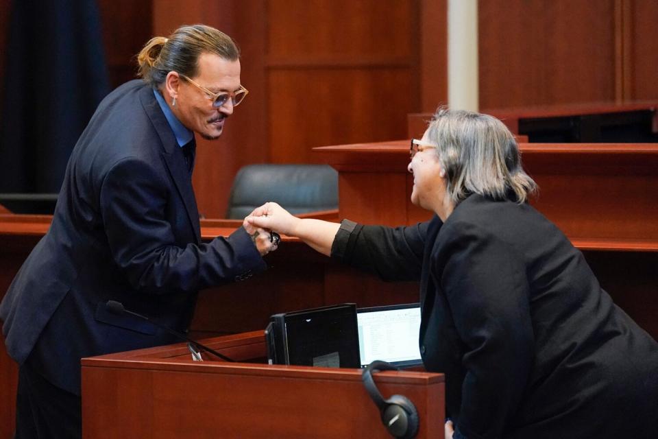 Actor Johnny Depp greets courtroom staff after closing arguments at the Fairfax County Circuit Courthouse in Fairfax, Virginia, on May 27, 2022. - Actor Johnny Depp is suing ex-wife Amber Heard for libel after she wrote an op-ed piece in The Washington Post in 2018 referring to herself as a public figure representing domestic abuse.