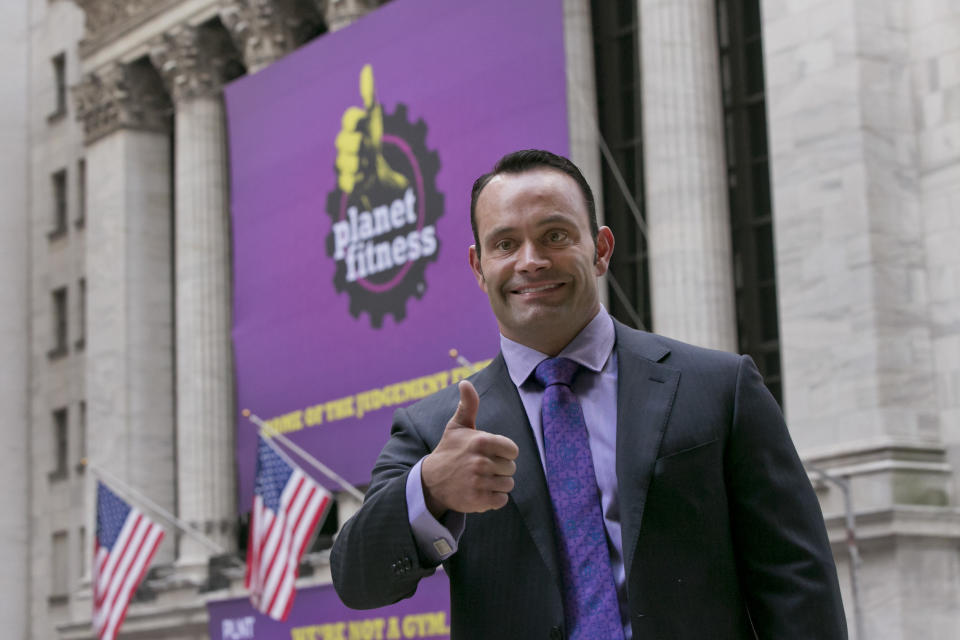 Planet Fitness CEO Chris Rondeau poses for photos in front of the New York Stock Exchange, prior to his company's IPO,  Thursday, Aug. 6, 2015.(AP Photo/Richard Drew)