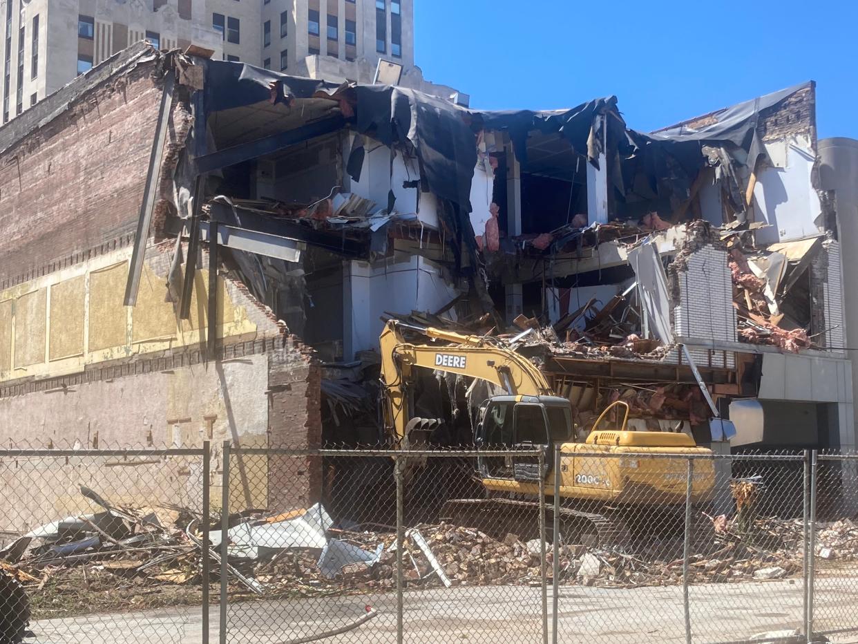 Demolition work began Wednesday on a building at 618 E. Washington St. Horace Mann is pressing forward on a redevelopment plan which would be a private and public green space/parking lot. Another building at 622 E. Washington St. has already been demolished.