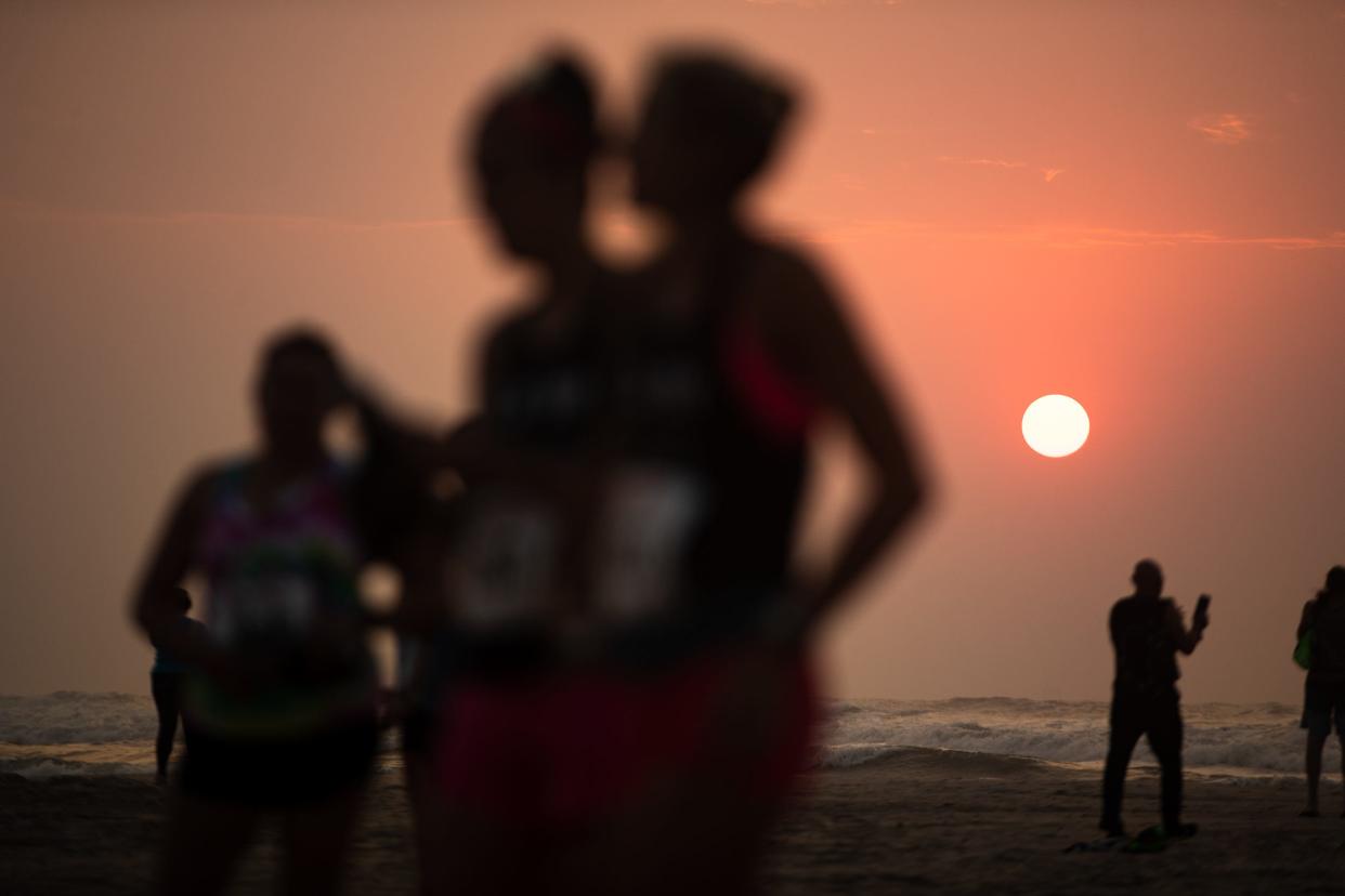 Runners prepare to compete in the Beach to Bay Relay Marathon at sunrise on Saturday, May 21, 2022. The race, which made its return after being cancelled the last two years due to COVID-19, began at JP Luby Beach and ended at McCaughn Park in Corpus Christi.