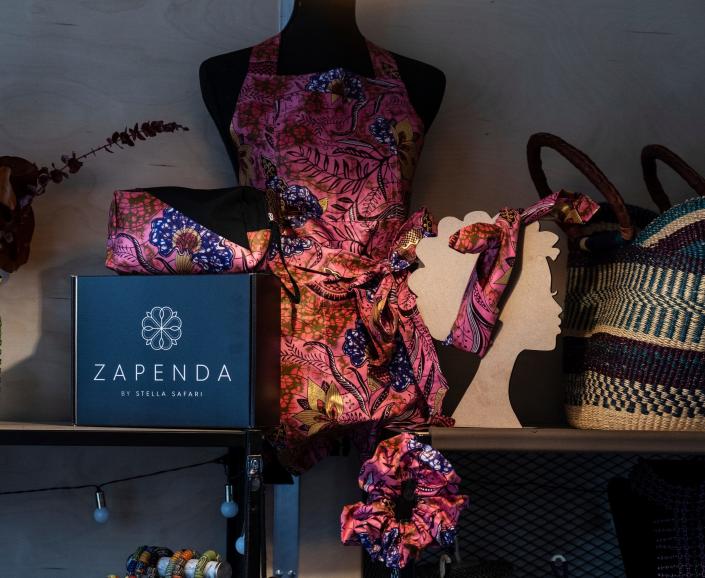 An apron, bandana scrunchie and a pouch are shown as gift items for holiday shoppers at the space for Zapenda in the Downtown Detroit Markets located at Cadillac Square in downtown Detroit on Wednesday, November 30, 2022.