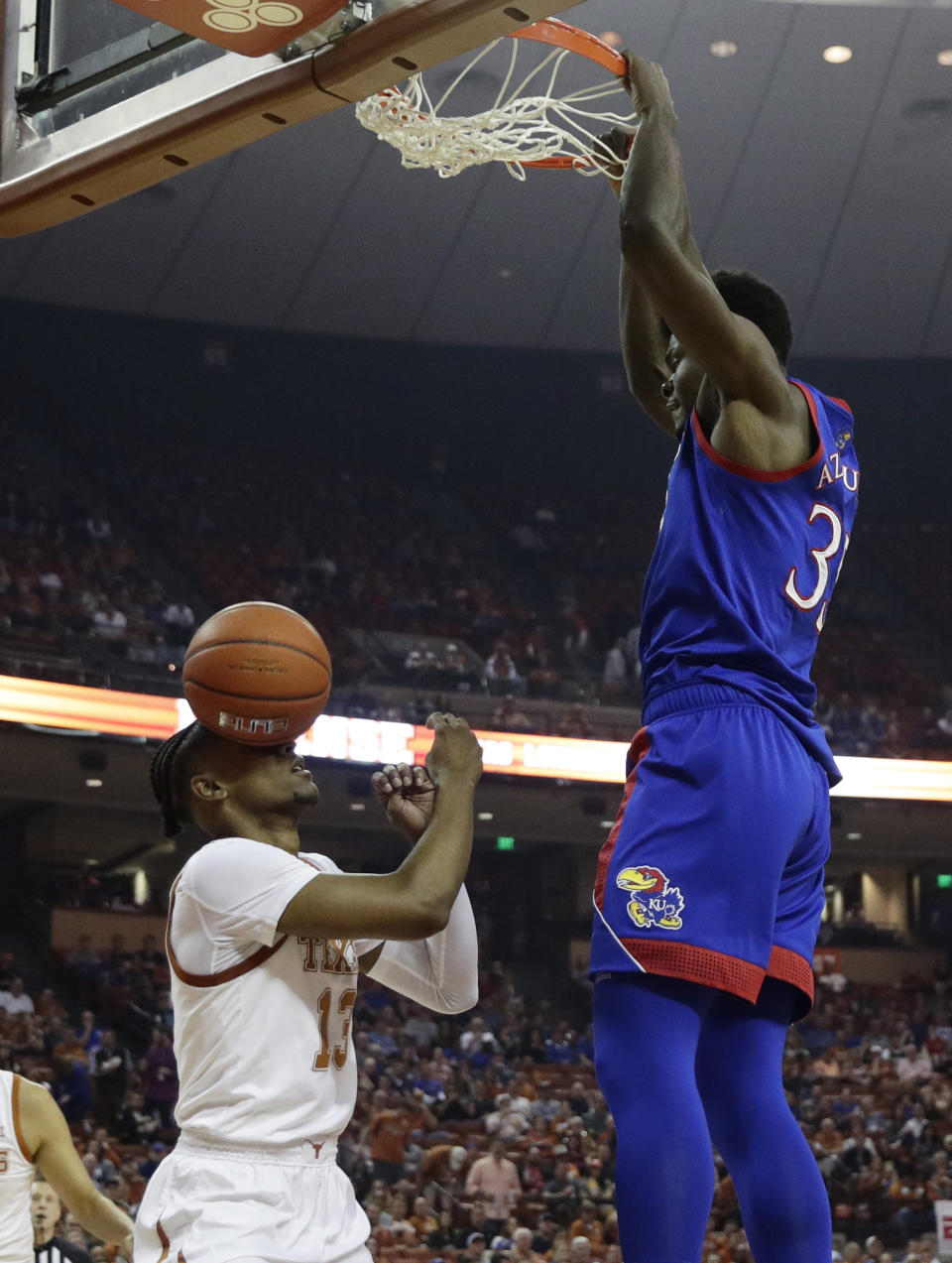 Kansas center Udoka Azubuike (35) score over Texas guard Jase Febres (13) during the first half of an NCAA college basketball game, Saturday, Jan. 18, 2020, in Austin, Texas. (AP Photo/Eric Gay)