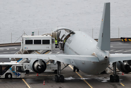 An injured German tourist involved in a bus accident is helped onto a German Air Force medical airplane at Cristiano Ronaldo Airport in Funchal, on the island of Madeira, Portugal April 20, 2019. REUTERS/Rafael Marchante