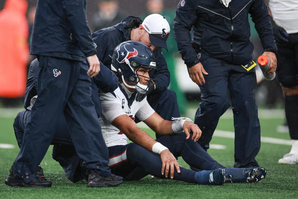 Houston Texans quarterback C.J. Stroud (7) with medical staff after suffering an apparent injury during the second half against the New York Jets at MetLife Stadium.