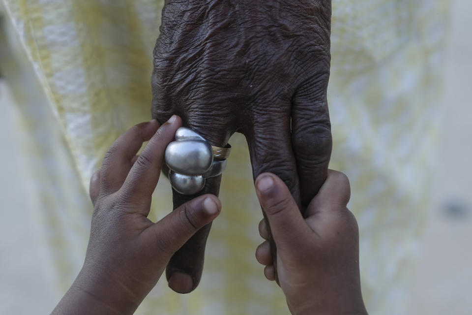 Eugenia Royer, 91, plays with her great-great-granddaughter in the Batey La Lecheria, a community of Haitian descendants, west of Santo Domingo, Dominican Republic, Monday, Nov. 22, 2021. Hundreds of thousands of Haitians are believed to live in the Dominican Republic, even before many fled Haiti in recent months in the wake of a presidential assassination, a 7.2 magnitude earthquake, a severe shortage of fuel and a spike in gang-related violence and kidnappings. (AP Photo/Matias Delacroix)