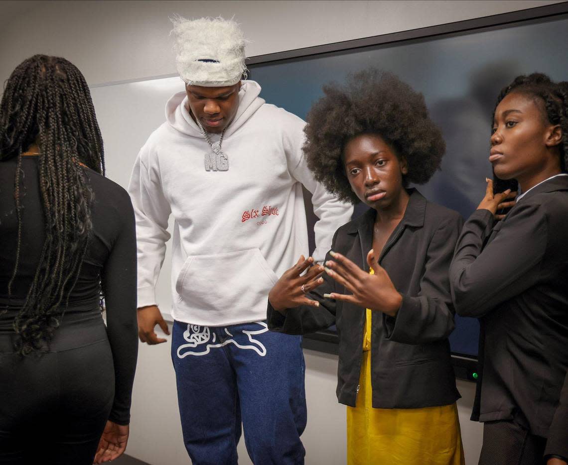 Grammy-nominated Francis Leblanc, left, known professionally as Fridayy, a Haitian-American singer, songwriter, and record producer, who made a personal appearance at Miami Dade College - Carrie P. Meek Entrepreneurial Education Center, waits to take pictures with student/fans on Thursday, April 4, 2024, in Miami, Florida. On the right is Wanda Tima, founder of “L’Union Suite,” a social media platform dedicated to positive news, features, and subjects regarding Haiti.