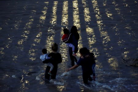 Migrants from Central America cross the Rio Bravo river to enter illegally into the United States as seen from Ciudad Juarez