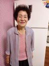 In this photo provided by Kang Myoung Suk, Chung Seong-ran, 84, poses for a photo at her home in Uiseong, South Korea, Wednesday, Sept. 16, 2020. The coronavirus forced Chung to do something new to celebrate South Korea's Thanksgiving holiday instead of being visited by her daughter. With a welfare worker's help, Chung sent a video greeting to her daughter for the first time in her life. (Courtesy of Kang Myoung Suk via AP)