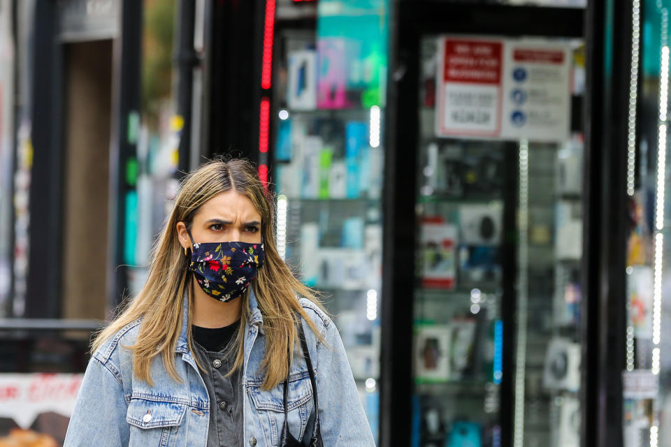 LONDON, UNITED KINGDOM - 2020/09/09: A woman wearing a face mask walks on the street.  The number of people who tested positive for the coronavirus is increasing. (Photo by Dinendra Haria/SOPA Images/LightRocket via Getty Images)