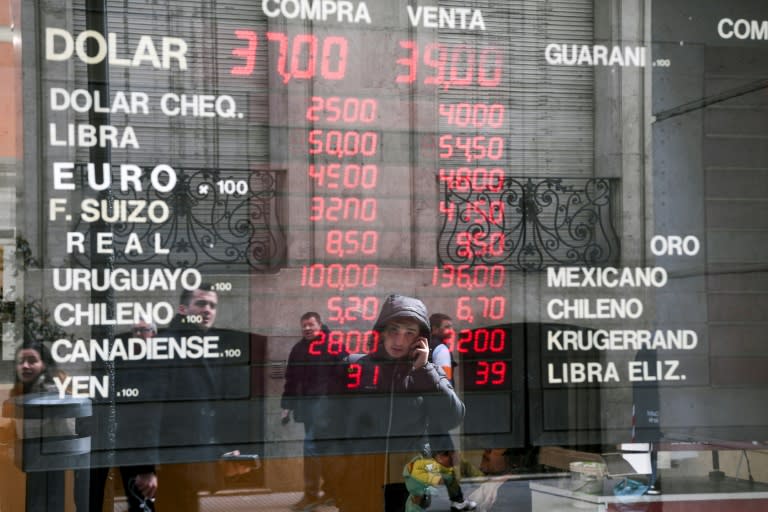 Currency exchange values are displayed on the window of a currency exhange in Buenos Aires