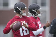 Atlanta Falcons quarterbacks Kirk Cousins, left, and Michael Penix Jr., right, run drills during an NFL football mini training camp practice on Tuesday, May 14, 2024, in Flowery Branch, Ga. (AP Photo/Brynn Anderson)