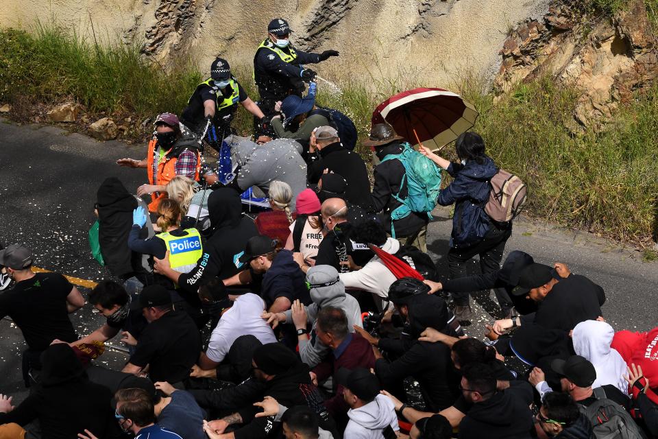 Police fire pepper spray at protesters during clash (EPA)