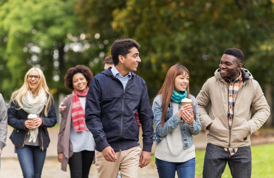 Group of diverse university students walking.