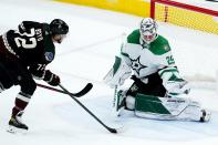 Dallas Stars goaltender Jake Oettinger (29) makes a save on a shot by Arizona Coyotes center Travis Boyd (72) during the first period of an NHL hockey game Sunday, Feb. 20, 2022, in Glendale, Ariz. (AP Photo/Ross D. Franklin)