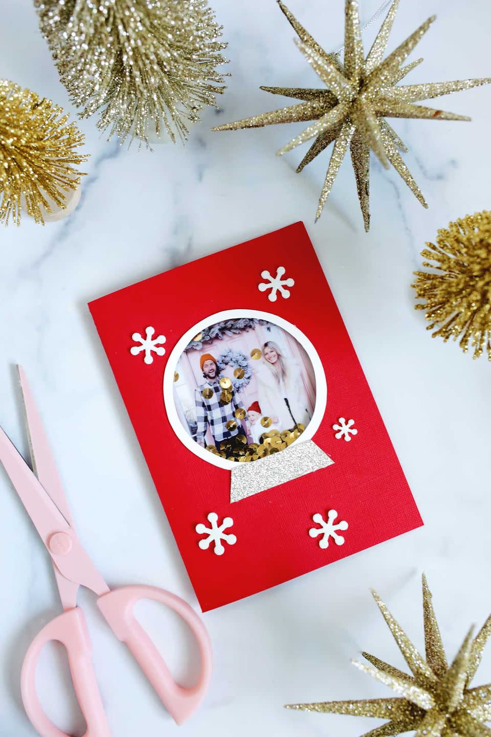 <p>Make your holiday card feel more personal by adding a festive photo of you and your family. Pick out your favorite card stock, print out a photo and follow this <a href="https://abeautifulmess.com/wp-content/uploads/2020/12/snow-globe-template.pdf" rel="nofollow noopener" target="_blank" data-ylk="slk:snow globe template;elm:context_link;itc:0;sec:content-canvas" class="link ">snow globe template</a>. Don't forget to decorate it with some <a href="https://www.amazon.com/Sumind-Snowflake-Self-Adhesive-Christmas-Decoration/dp/B07HTB9S85?tag=syn-yahoo-20&ascsubtag=%5Bartid%7C10055.g.4080%5Bsrc%7Cyahoo-us" rel="nofollow noopener" target="_blank" data-ylk="slk:snowflake stickers;elm:context_link;itc:0;sec:content-canvas" class="link ">snowflake stickers</a>! </p><p><a href="https://abeautifulmess.com/snow-globe-photo-card-diy/" rel="nofollow noopener" target="_blank" data-ylk="slk:Get the tutorial at A Beautiful Mess »;elm:context_link;itc:0;sec:content-canvas" class="link "><em>Get the tutorial at A Beautiful Mess »</em></a></p>