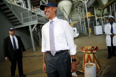 U.S. President Barack Obama laughs after commenting on his press corps, who were wearing hair nets on a tour of the Faffa Food factory in Addis Ababa, Ethiopia July 28, 2015. REUTERS/Jonathan Ernst