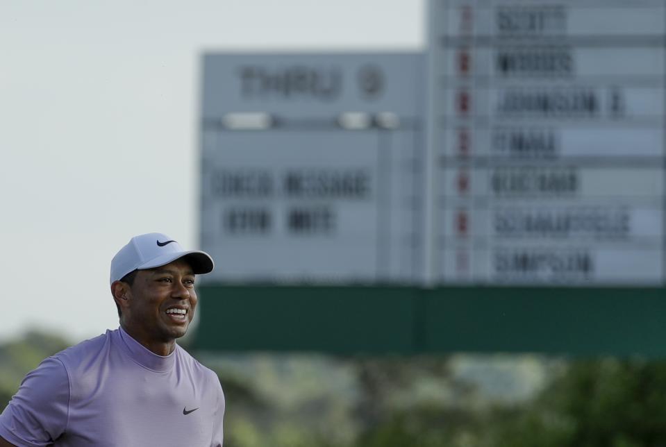 Tiger Woods smiles as he walks off the 18th green during the third round for the Masters golf tournament Saturday, April 13, 2019, in Augusta, Ga. (AP Photo/Chris Carlson)