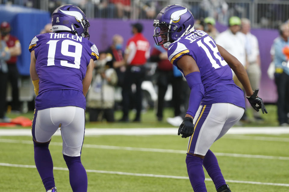 Minnesota Vikings wide receiver Justin Jefferson (18) celebrates with teammate Adam Thielen (19) after catching a 9-yard touchdown pass during the second half of an NFL football game against the Green Bay Packers, Sunday, Nov. 21, 2021, in Minneapolis. (AP Photo/Bruce Kluckhohn)