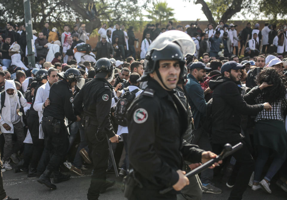 Security forces attempt to control protesting teachers during a demonstration in Rabat, Morocco, Wednesday, Feb. 20, 2019. Moroccan police fired water cannons at protesting teachers who were marching toward a royal palace and beat people with truncheons amid demonstrations around the capital Wednesday. (AP Photo/Mosa'ab Elshamy)