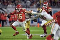Kansas City Chiefs' quarterback Patrick Mahomes, left, tries to scramble away from San Francisco 49ers' Dee Ford, center, and DeForest Buckner, right, during the second half of the NFL Super Bowl 54 football game Sunday, Feb. 2, 2020, in Miami Gardens, Fla. (AP Photo/Mark J. Terrill)