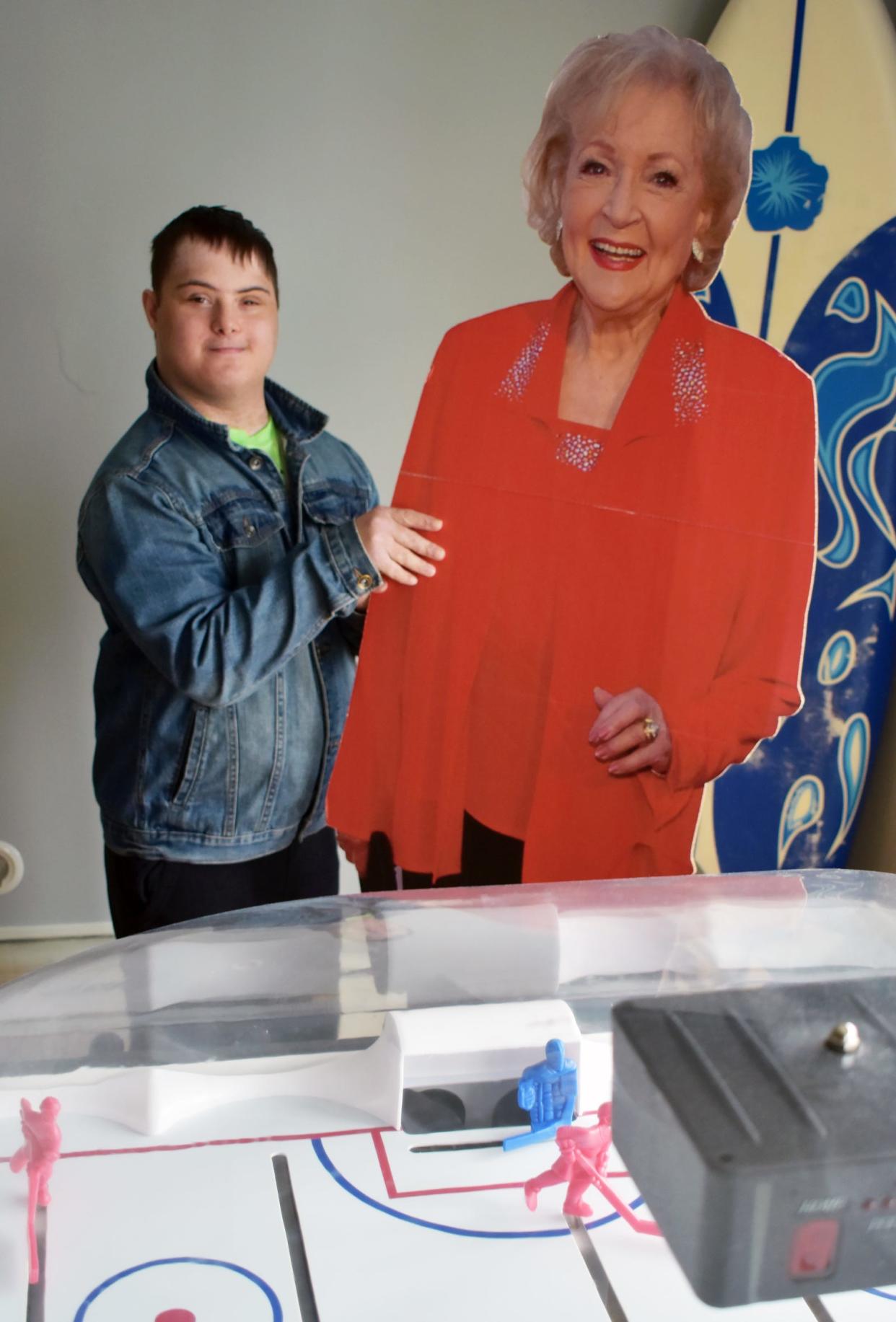 Somerset resident Alex Rogers, known around town as "Superhero Alex," is seen at his home with a cutout of Betty White one of his favorite "Golden Girls" characters.