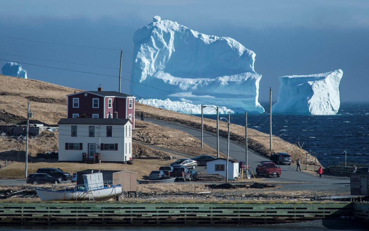 Residents view the first iceberg of the season as it passes the South Shore, also known as
