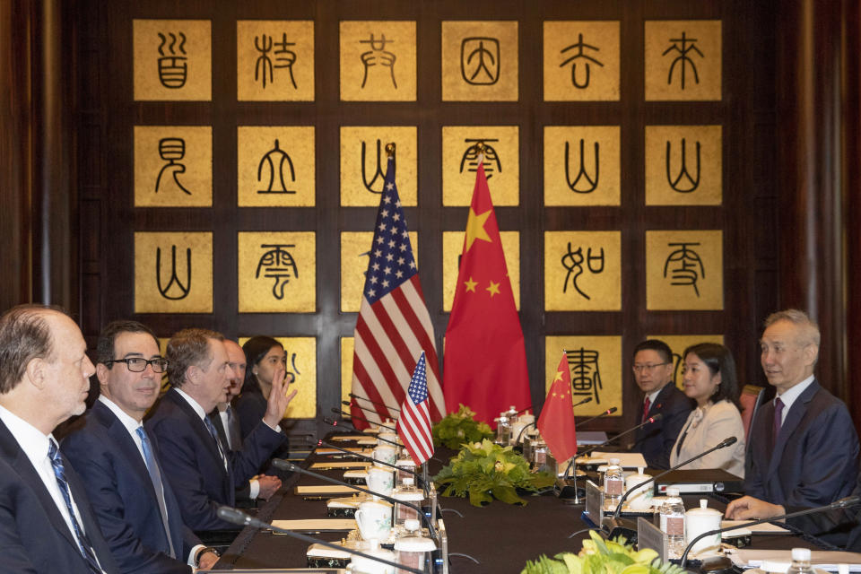 CORRECTS SPELLING TO STEVEN INSTEAD OF STEVE - Chinese Vice Premier Liu He, right, looks over as U.S. Trade Representative Robert Lighthizer, third from left, gestures near Treasury Secretary Steven Mnuchin, second from left, before the start of talks at the Xijiao Conference Center in Shanghai Wednesday, July 31, 2019. (AP Photo/Ng Han Guan, Pool)