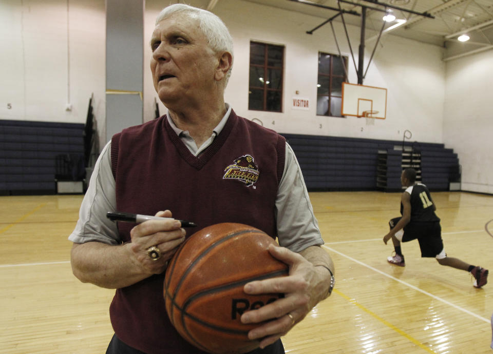 FILE - In this Wednesday, Feb. 2, 2011, file photo, Bob Hurley, head coach of the St. Anthony High School boys' basketball team, signs a game ball in Jersey City, N.J. In a half century at St. Anthony's, Hall of Fame basketball coach Bob Hurley has won on an almost unparalleled level in high school. But now the school that has been a haven to the poor seeking a Roman Catholic education could soon be closing its doors. (AP Photo/Julio Cortez, file)