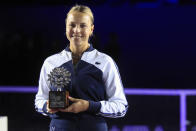 Anett Kontaveit, of Estonia, poses with her trophy after being defeated by Garbiñe Muguruza, of Spain, during the final match of the WTA Finals tennis tournament in Guadalajara, Mexico, Wednesday, Nov. 17, 2021. (AP Photo/Refugio Ruiz)