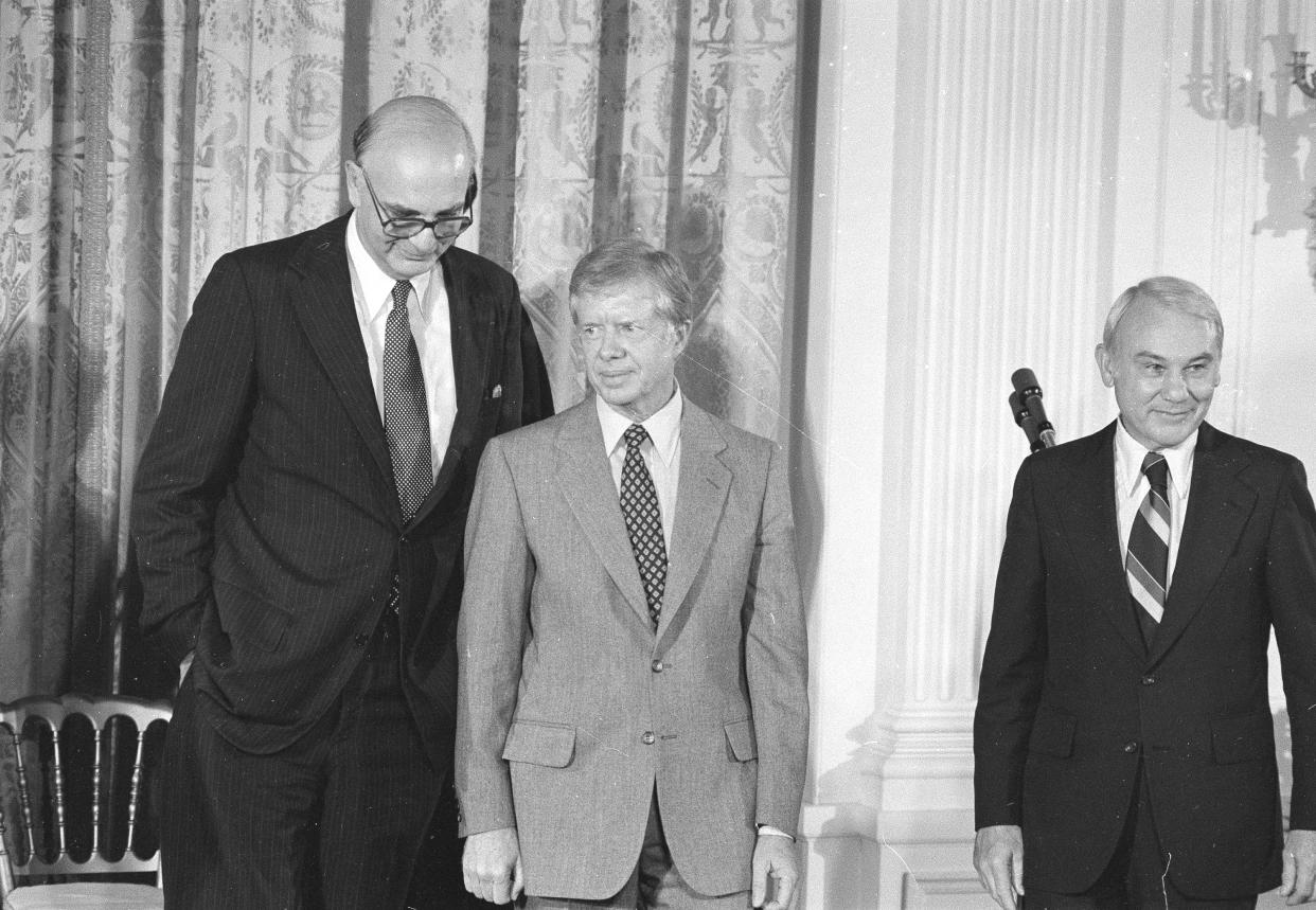 President Jimmy Carter stands with Paul Volcker left, at the White House Monday August 6, 1979 as he was sworn in as the Chairman of the Federal Reserve Board . At right is G. William Miller, sworn in at the same ceremony as Treasury Secretary. ( AP Photo/STF )