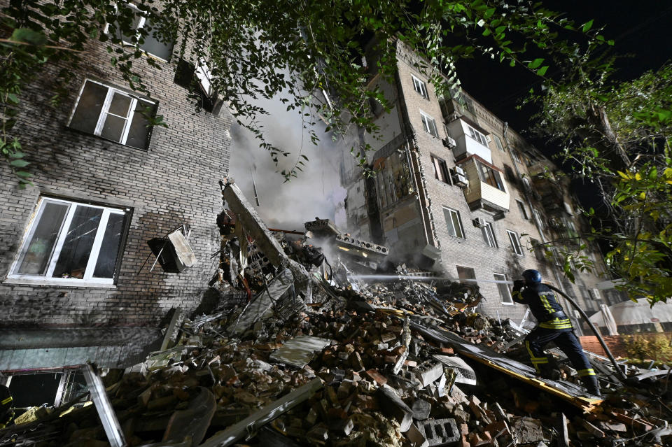 A rescuer works at a site of a residential building heavily damaged by a Russian missile strike, amid Russia's attack on Ukraine, in Zaporizhzhia, Ukraine October 10, 2022. REUTERS/Stringer