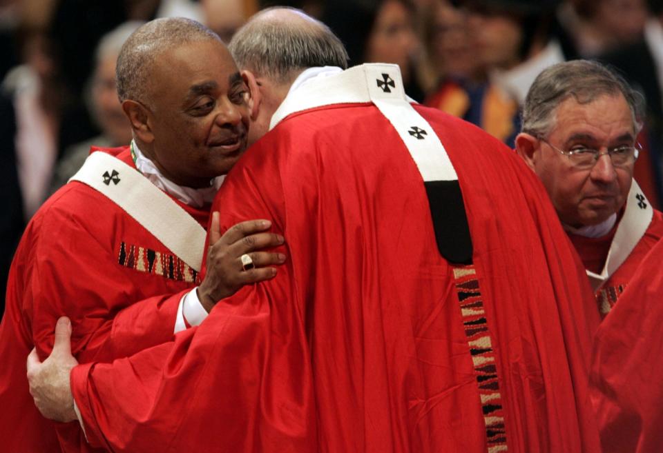 Msgr. Wilton Gregory and Msgr. Joseph F. Naumann embrace at St. Peter's Basilica in June 2005.