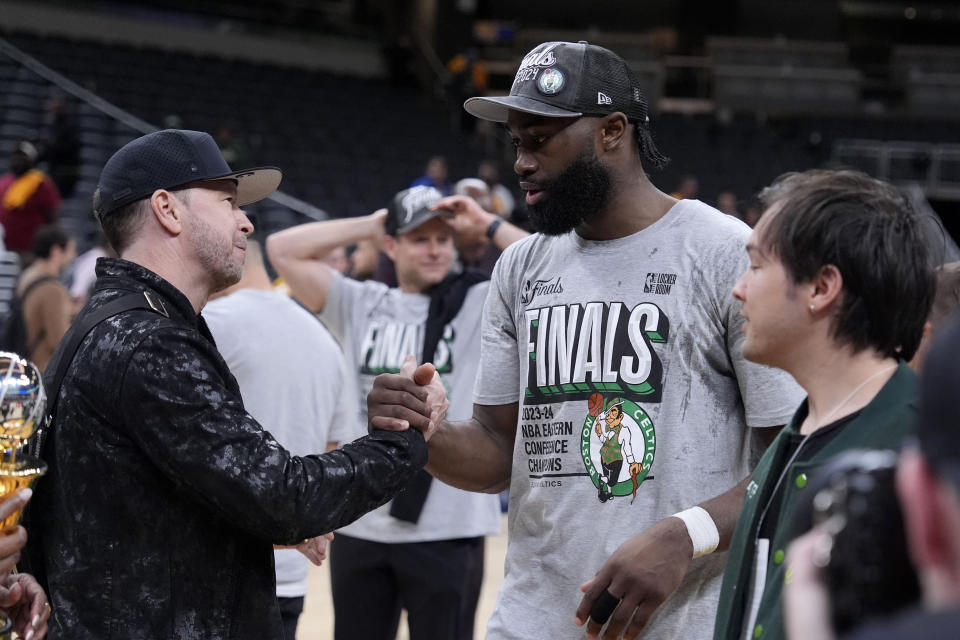 Boston Celtics guard Jaylen Brown celebrates with actor Donnie Wahlberg, left, after Game 4 of the NBA Eastern Conference basketball finals against the Indiana Pacers, Monday, May 27, 2024, in Indianapolis. The Celtics won 105-102.(AP Photo/Michael Conroy)