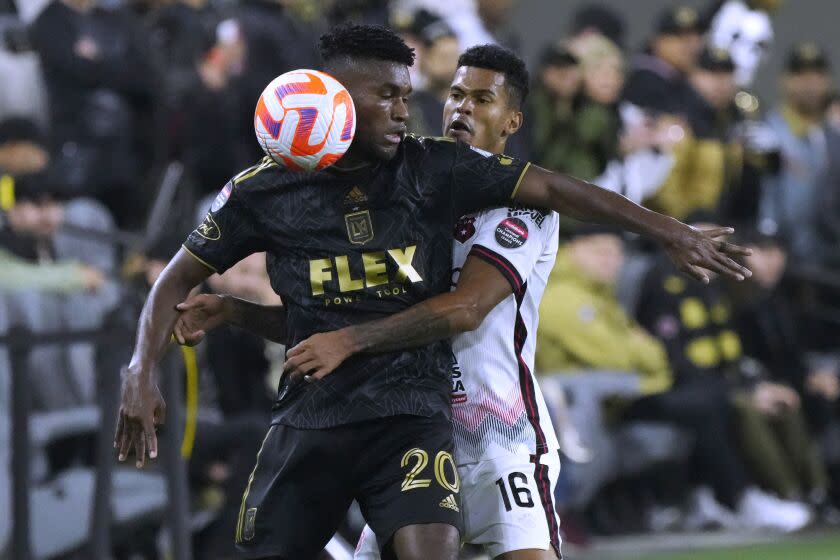 Los Angeles' Jose Cifuentes (20) defends Alajuelense's Yael Lopez during the second half of a CONCACAF Champions League football game on Wednesday, March 15, 2023, in Los Angeles.  (AP Photo/Marcio Jose Sanchez)