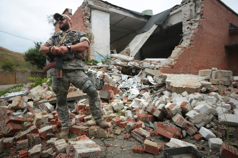 A Ukrainian paratrooper walks among the ruins of a building destroyed in shelling by pro-Russian separatists, in east Ukraine's Donetsk region, on August 14, 2016