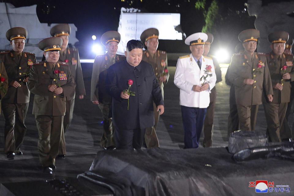 In this undated photo provided on Monday, July 27, 2020, by the North Korean government, North Korean leader Kim Jong Un, center, with military officers in uniforms prepares to lay a flower to the Fatherland Liberation War Martyrs' Cemetery in Pyongyang, North Korea. Independent journalists were not given access to cover the event depicted in this image distributed by the North Korean government. The content of this image is as provided and cannot be independently verified. Korean language watermark on image as provided by source reads: "KCNA" which is the abbreviation for Korean Central News Agency. (Korean Central News Agency/Korea News Service via AP)