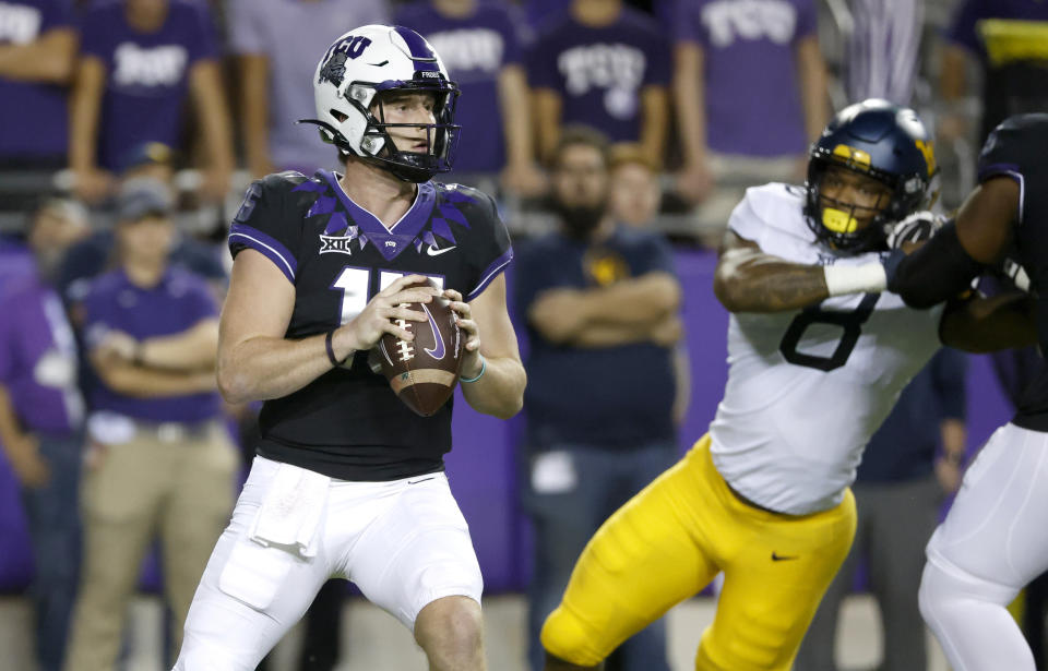 TCU quarterback Max Duggan (15) looks to throw as West Virginia linebacker VanDarius Cowan (8) closes in during the first half of an NCAA college football game Saturday, Oct. 23, 2021, in Fort Worth, Texas. (AP Photo/Ron Jenkins)