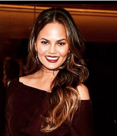 Chrissy Teigen looks like a tall glass of merlot in her wine-colored getup