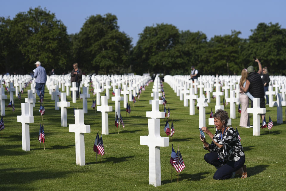 People take picturesa at an US cemetery near Colleville-sur-Mer Normandy, Thursday, June 6, 2024. World War II veterans from across the United States as well as Britain and Canada are in Normandy this week to mark 80 years since the D-Day landings that helped lead to Hitler's defeat. (AP Photo/Laurent Cipriani)