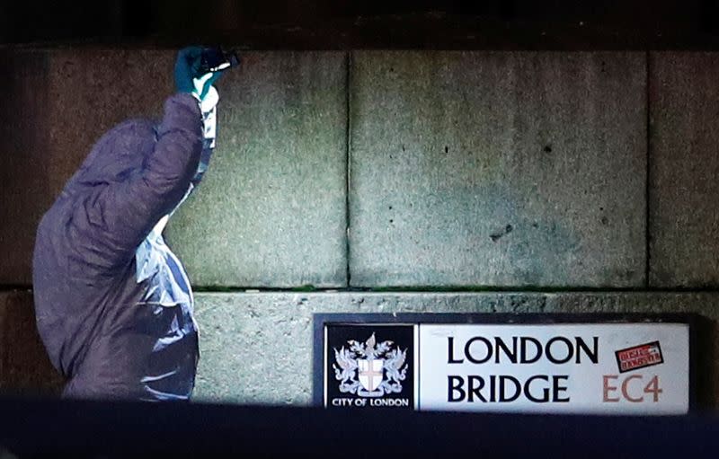 A forensics officer is seen near the site of an incident at London Bridge in London