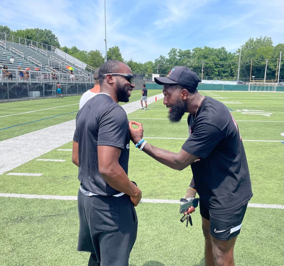 Former St. Vincent-St. Mary and Ohio State stars Doran Grant (left) and Parris Campbell share a laugh during a 2022 Nike Football Skills Camp. Grant is set to become STVM's next head football coach.