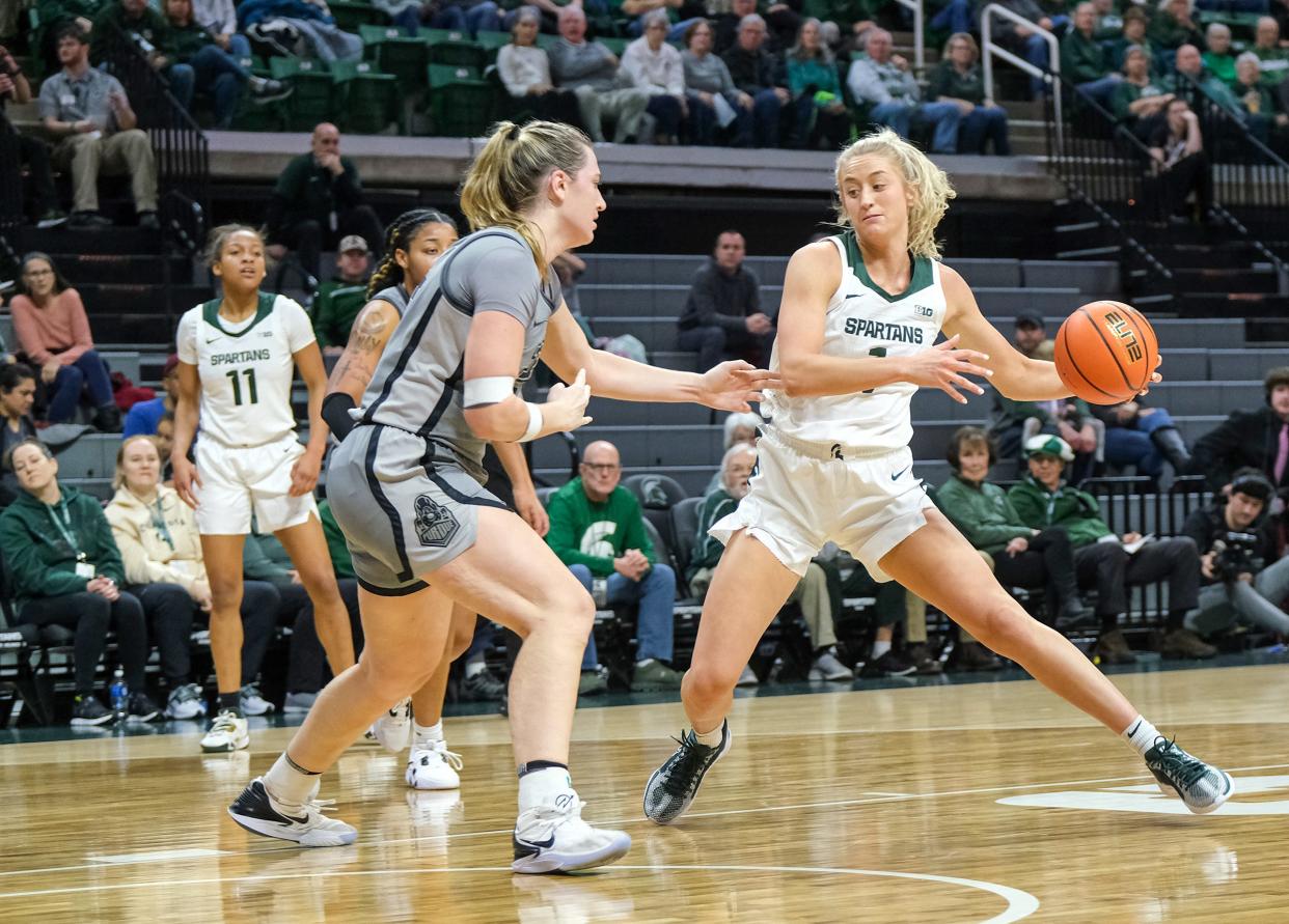 Michigan State's Tory Ozment (1) drives to the basket and is fouled by Purdue's Caitlyn Harper (34) in Big 10 action at Breslin Wednesday, Jan. 24, 2024. Ozment made the basket and the free throws.