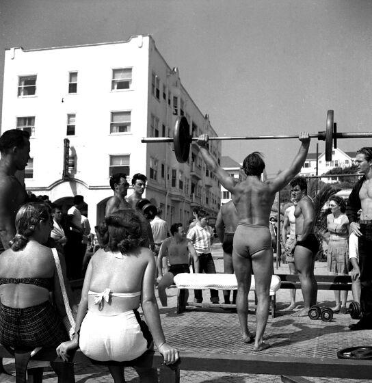 LOS ANGELES - JULY 24: A muscle builder lifts weights at Muscle Beach on July 24, 1949 in Santa Monica, California. (Photo by Earl Leaf/Michael Ochs Archives/Getty Images)