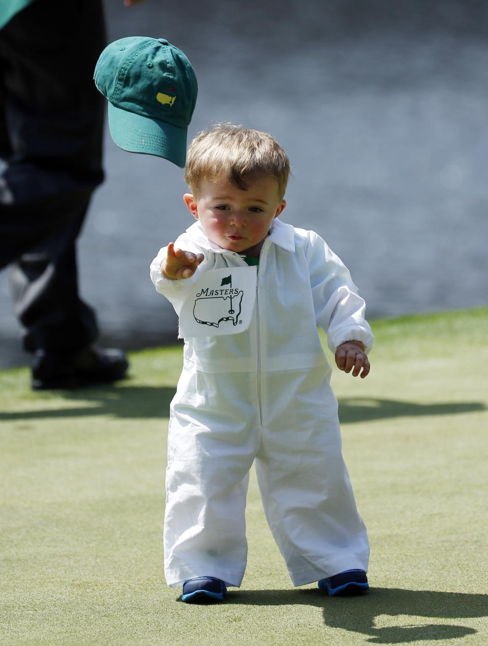 Scott Stallings's son Finn throws off his cap on the fourth green during the par three competition at the Masters golf tournament Wednesday, April 9, 2014, in Augusta, Ga. (AP Photo/Matt Slocum)