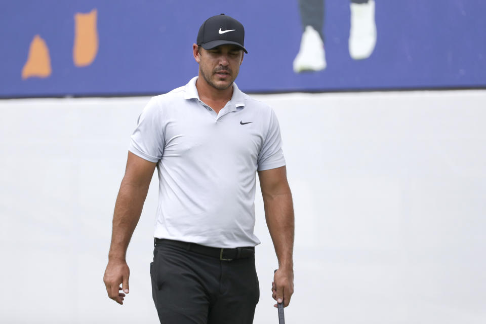 Brooks Koepka walks across the practice green at the World Golf Championships-FedEx St. Jude Invitational Wednesday, July 29, 2020, in Memphis, Tenn. Koepka, who won three times last year is trying to defend his FedEx St. Jude Invitational title with an injured left knee that has had him putting more weight on his right leg and affecting his game. (AP Photo/Mark Humphrey)