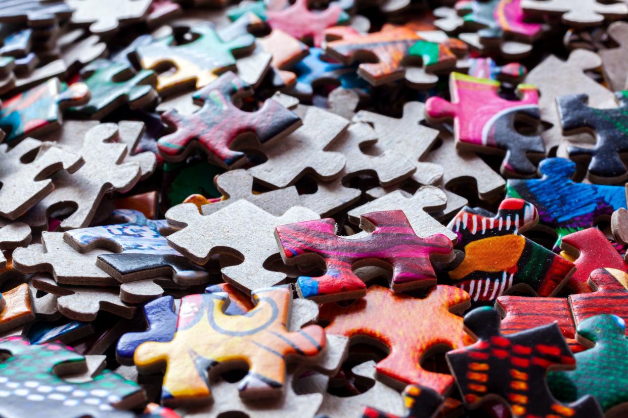 Disassembled puzzle colored pieces