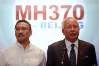 REFILE WITH ADDITIONAL INFORMATION Malaysian Prime Minister Najib Razak (R) addresses reporters as Transport Minister Hishammuddin Hussein stands by him, at the Kuala Lumpur International Airport March 15, 2014. Najib said on Saturday that the movements of the missing Malaysia Airlines Flight MH370 were consistent with a deliberate act by someone who turned the jet back across Malaysia and onwards to the west. REUTERS/Damir Sagolj (MALAYSIA - Tags: DISASTER TRANSPORT POLITICS TPX IMAGES OF THE DAY)