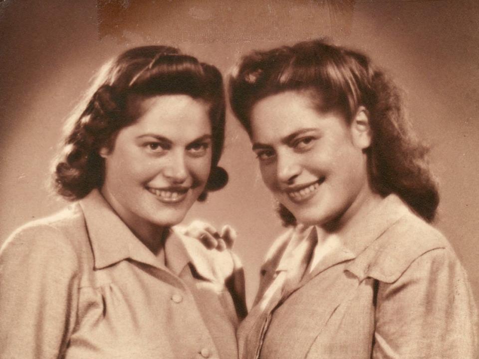 Identical twin sisters Annetta Able and Stepha Heller pose in their mid-20s.