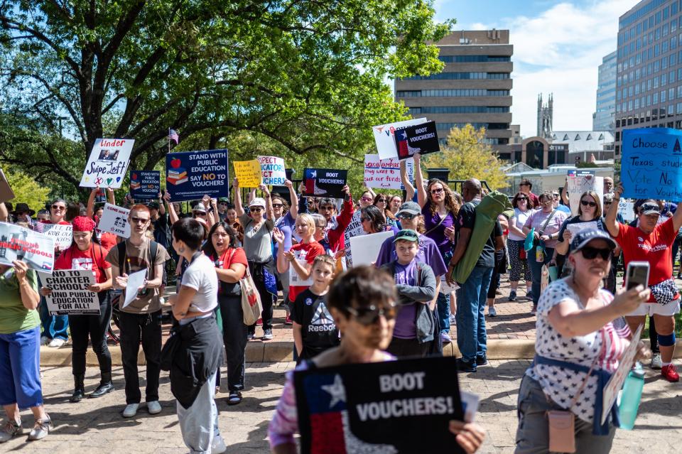 Educators gather at the Capitol on Oct. 7 to show their opposition to school choice programs that would use public money to help pay for education at private schools.